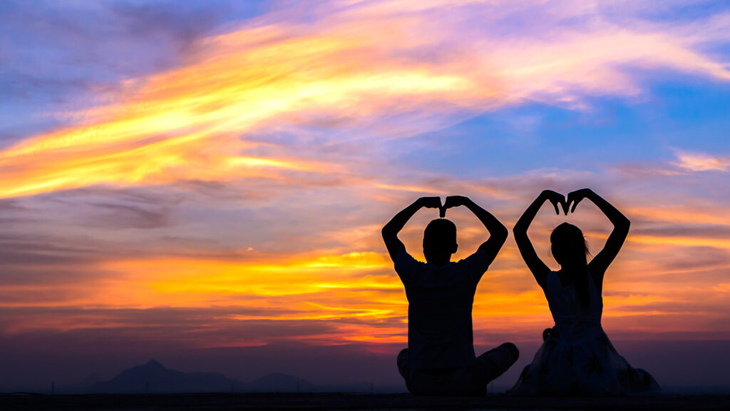 Silhouetted couple or individual in meditative stillness representing sacred sexuality, body awareness, and spiritual intimacy
